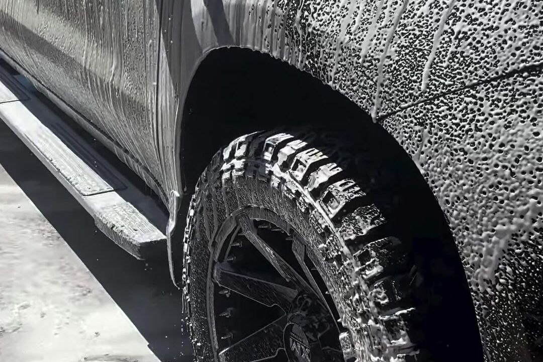 Black Chevy Silverado covered in thick wash foam
