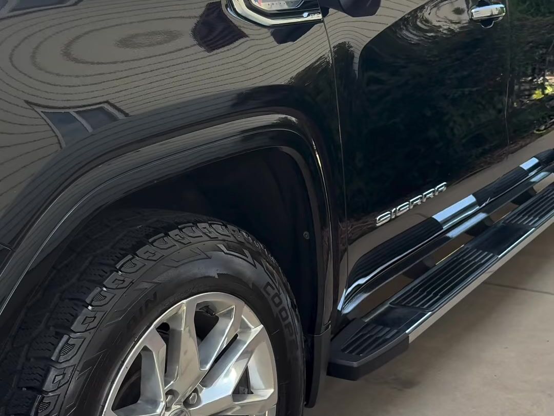 Black GMC Sierra side panel shining after an exterior wash
